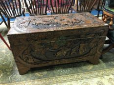 A heavily carved Oriental camphor wood chest