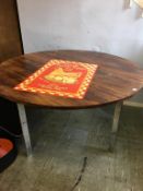 A circular Merrow Associates 'Rio' rosewood dining table, with chrome legs, 137cm diameter