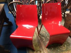 Pair of red plastic Pedrali chairs