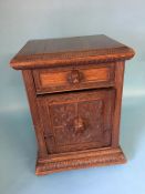 A heavily carved oak coal box, with dogs head carved handles, 44cm wide