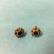 A pair of 9ct gold garnet stud earrings