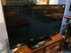 A Hitachi 44" TV, with remote