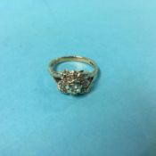 A 9ct gold nine stone diamond flower ring, size 'M'