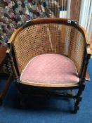 An Edwardian bergère tub chair