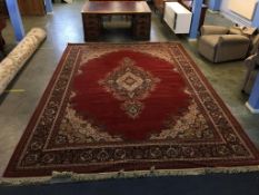 A large red ground pattern carpet square, 410cm length, 300cm wide