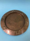 An Arts and Crafts circular copper wall plate, 28cm diameter
