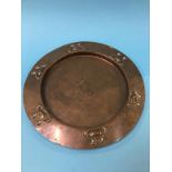 An Arts and Crafts circular copper wall plate, 28cm diameter