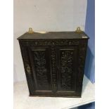 An antique carved oak spice cupboard, 48cm wide, 55cm height