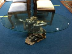 A glass top oval coffee table, with decorative figural support, 111cm length