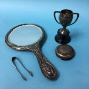 A silver backed mirror and small silver trophy etc.
