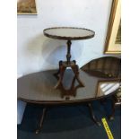 A reproduction mahogany oval coffee table and an occasional table