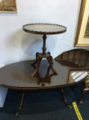 A reproduction mahogany oval coffee table and an occasional table