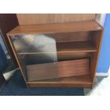 A teak sliding door bookcase, 91cm wide