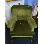 A green upholstered armchair