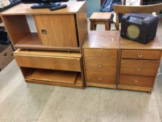 Two teak cabinets and a pair of bedside drawers