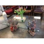 A rectangular glass top coffee table and a pair of figural supports, 119 x 70cm