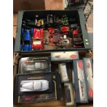 A collection of Die Cast toys in two trays