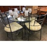 A glass circular table and four chairs