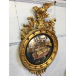 A Regency style gilt mirror, surmounted by an eagle, 110 x 62cm