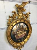 A Regency style gilt mirror, surmounted by an eagle, 110 x 62cm