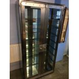 An industrial style two door glazed display cabinet, 90cm wide, 46cm deep, 182cm height