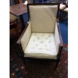 An Edwardian mahogany armchair with button seat, supported on turned legs and brass castors