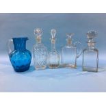 Four decanters and a jug