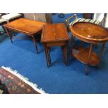 A yew wood coffee table, nest of tables and a two tier oval occasional table