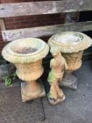 A pair of composite planters and a figure
