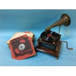 A wind up table top gramophone and various records