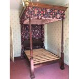 A mahogany four poster bed with fluted and reeded columns and a carved headboard, 195 x 138cm