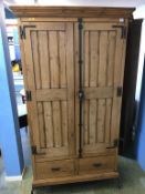 A pine two door hall cabinet / coat stand, with two drawers, 104cm wide, 37cm deep