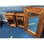 A wood framed mirror and a pair of bedside drawers