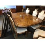 A modern oak extending dining table and eight chairs, includes leaves