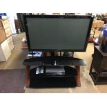 A Samsung TV and stand, with remote ( in office )