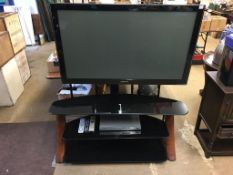 A Samsung TV and stand, with remote ( in office )