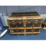 A wood and metal bound steamer trunk