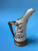 A Royal Worcester ewer, decorated with flowers and simulated horn handles