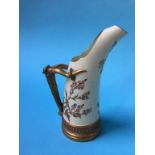 A Royal Worcester ewer, decorated with flowers and simulated horn handles