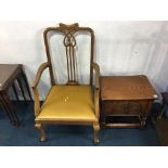 An armchair and a small carved oak chest