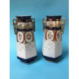 A pair of gilded Edwardian vases decorated with panels of flowers
