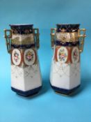 A pair of gilded Edwardian vases decorated with panels of flowers