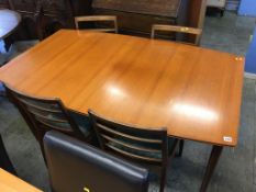A McIntosh teak extending dining table and four chairs