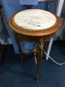 A marble top plant stand, with gilt metal mounts, 41cm diameter, 76cm high