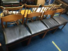 A set of four teak dining chairs