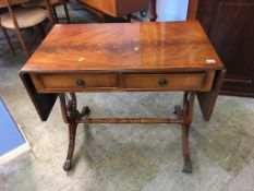 A reproduction mahogany sofa table