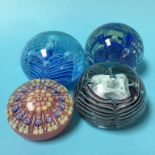 A collection of four paperweights
