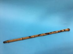 A carved bamboo walking cane