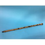 A carved bamboo walking cane