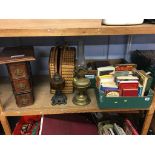 A shelf of assorted books and oil lamps